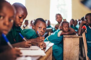 Photo by Annie Spratt children writing in books